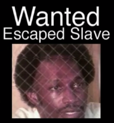 2015 or 1866??? Screenshot of a black man labeled as a "Wanted Escaped Slave" from former Fort Laudersale cop Alex Alvarez's disgusting movie trailer THE HOOD, created using iPhone app iMovie. 2015 Naples Ninja News. All rights reserved.